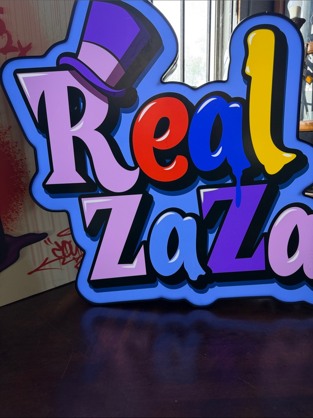Colorful 'Real ZaZa' Graphic Sign - Bold Multicolor Pop Art